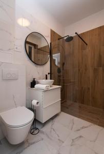 a bathroom with a toilet and a sink and a mirror at City Centre Apartment Iva in Split +7 photos