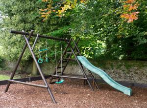 a playground with a slide in a park at The Murray Park Hotel in Crieff