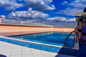a swimming pool on the roof of a building at Mogul's Palace (3 beds) Thika town in Thika