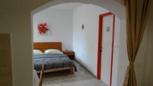 a bedroom with a bed and a door to a hallway at Apartment Rosabela in Primošten
