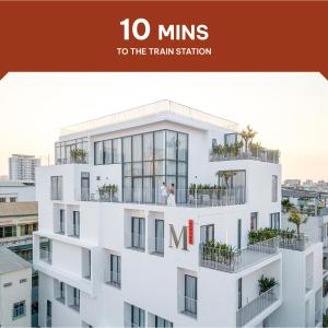 a picture of a building with the words mins to the train station at M Village Kỳ Đồng in Ho Chi Minh City
