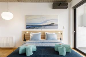 a bedroom with a bed with two pillows at The Hostmaster Persephone Turquoise Opulence 1st floor in Athens