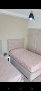 a bedroom with two beds and a lamp at Appartement Costa Mar Martil in Martil +68 photos