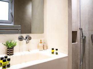a bathroom sink with a mirror and a shower at Catherine Luxury Holiday House close to Corfu Town in Potamós +63 photos
