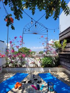 a view of a swimming pool with shoes and flowers at LUCA HOTEL Heritage Residences Signature Collection in Santo Domingo