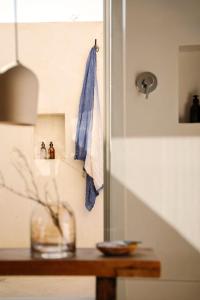 a towel hanging on a wall next to a table at Simbavati Cederberg Ridge in Clanwilliam