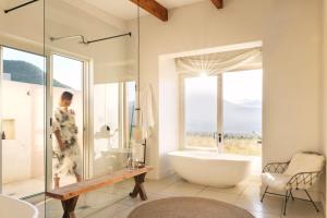 a bathroom with a large tub and a window at Simbavati Cederberg Ridge in Clanwilliam