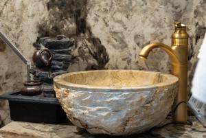a sink with a gold faucet in a bathroom at Luxury Room in Dijon