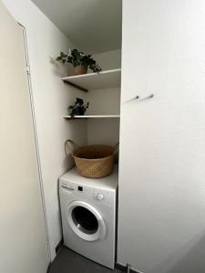 a washer and dryer in a room with a wall at Moderne lejlighed i hjertet af Odense C in Odense