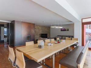 a dining room with a large wooden table and chairs at Luxurious Holiday Home in Krimml with Sauna in Krimml