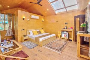 a bedroom with a bed in a room with wooden walls at Regal Retreat in Jari