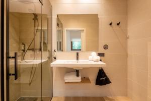 a bathroom with a sink and a shower at Leonardo Hotel San Sebastián in Donostia-San Sebastián