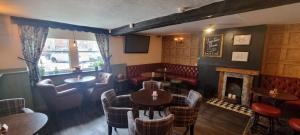 a restaurant with tables and chairs and a fireplace at The Bishop Blaize in Richmond