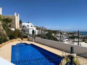 a swimming pool on the balcony of a house at RESIDENCIAL OASIS 5 in Mojácar
