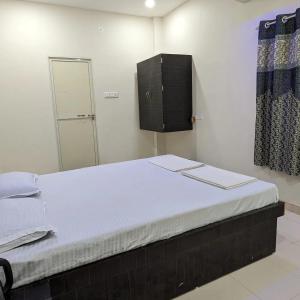a bedroom with a large bed with a mirror at AATITHYA HOME STAY in Ujjain