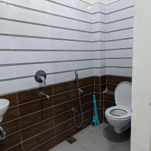 a bathroom with a toilet and a sink at AATITHYA HOME STAY in Ujjain