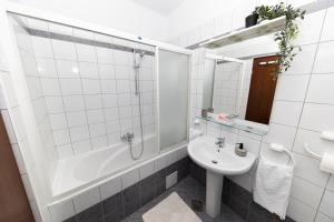 a white bathroom with a sink and a shower at Apartment Nea Zadar in Zadar +19 photos
