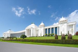 a large white building on a green lawn at The Land Of Legends Kingdom Hotel - All-in Concept in Belek