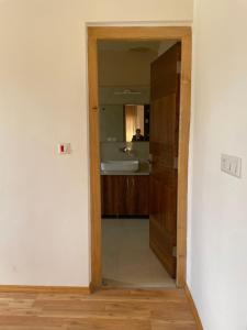 a bathroom with a mirror and a sink in a room at Dgha-Ldhan Guest House in Leh