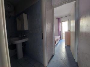 a bathroom with a sink and a mirror at Bilocale per l'affitto estivo in Torre Pali