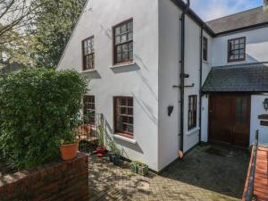 an exterior view of a white house with a door at The Laurels Flat in Cardiff