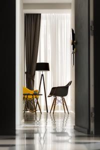 a room with two chairs and a table and a window at Navona Theatre Hotel in Rome
