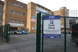 a sign on a gate in front of a parking lot at Modern and Comfy in City Centre PS4 , Free Parking ,Walking Distance To Bus, Train Stations And Shopping Centres in Leicester