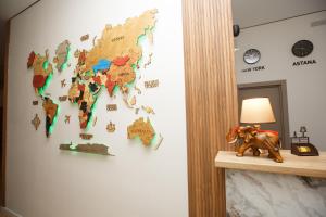 a map of the world is on a wall at Отель Asyl in Astana
