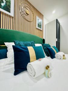 a bedroom with a large bed with blue and yellow pillows at GuestReady - Amazing Studio near Disneyland in Montévrain
