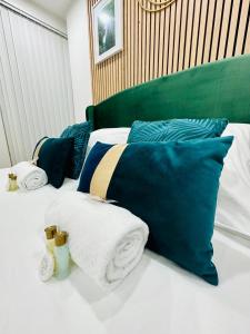 a bed with blue and white pillows and towels at GuestReady - Amazing Studio near Disneyland in Montévrain