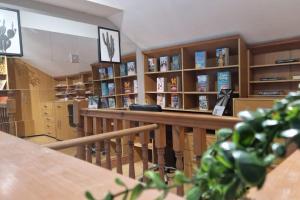 a library with shelves of books and a table at Great Liverpool Location! in Liverpool