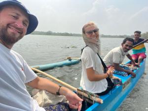 a group of people in a boat on the water at Bulnewa Grammar International home stay/Tree-house 