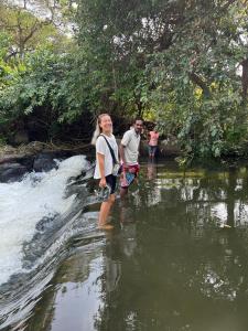 a man and a woman standing in a river at Bulnewa Grammar International home stay/Tree-house 