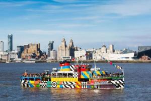 a colorful boat in the water near a city at Great Liverpool Location! in Liverpool