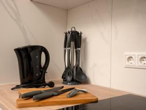 a kitchen counter with utensils on a cutting board at Serviceroom24 - Apartment 4 in Herten WLAN - Smart-TV - 24-7 Check-in und Küche in Herten