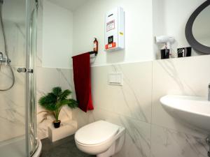 a white bathroom with a toilet and a sink at SR24 - Wohnung 4 in Herten in Herten