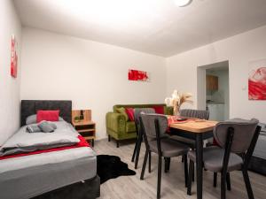 a bedroom with a bed and a table and chairs at SR24 - Wohnung 4 in Herten in Herten