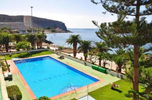 a swimming pool with a view of the ocean at COMODORO- RAVEL in Los Cristianos
