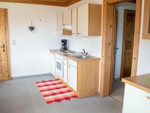 a small kitchen with a sink and a stove at Rauchenbacher Apartments Mittersill in Mittersill