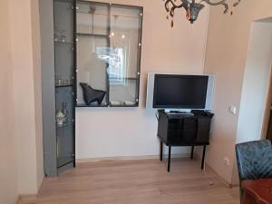 a living room with a television on a table at 3min walk to Vilnius business center in Vilnius