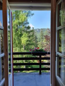 an open door to a porch with a view at B&B Cristallo in Cortina dʼAmpezzo