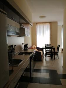 a kitchen and living room with a table and chairs at Guest House SNG in Nesebar