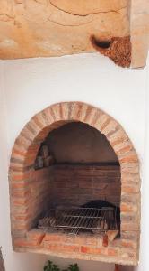 a brick oven with a fire inside of it at Quinta das Pedras - Tavira in Tavira