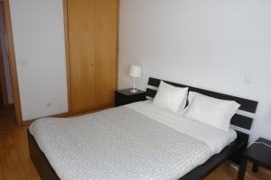 a bed with white sheets and pillows in a room at Best Apartments Portugal in Lisbon