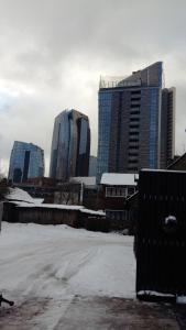 a parking lot with snow in front of tall buildings at 3min walk to Vilnius business center in Vilnius