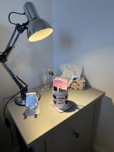 a desk with a lamp and a cup on it at Bodmin Rest 4 U in Bodmin
