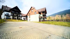 a large house on a road in front of a house at Apartamenty Every Sky Szklarska Poręba, Żeromskiego 15c-5 in Szklarska Poręba