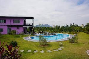 a swimming pool in a yard next to a house at VIOLET VILLA in Hòa Bình