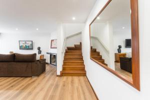 a living room with a staircase and a couch at GuestReady - Vacation family home near the beach in Esposende