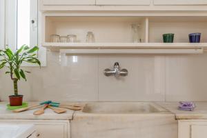 a kitchen counter with a sink and a sink at Modern Cosy Apt in Athens